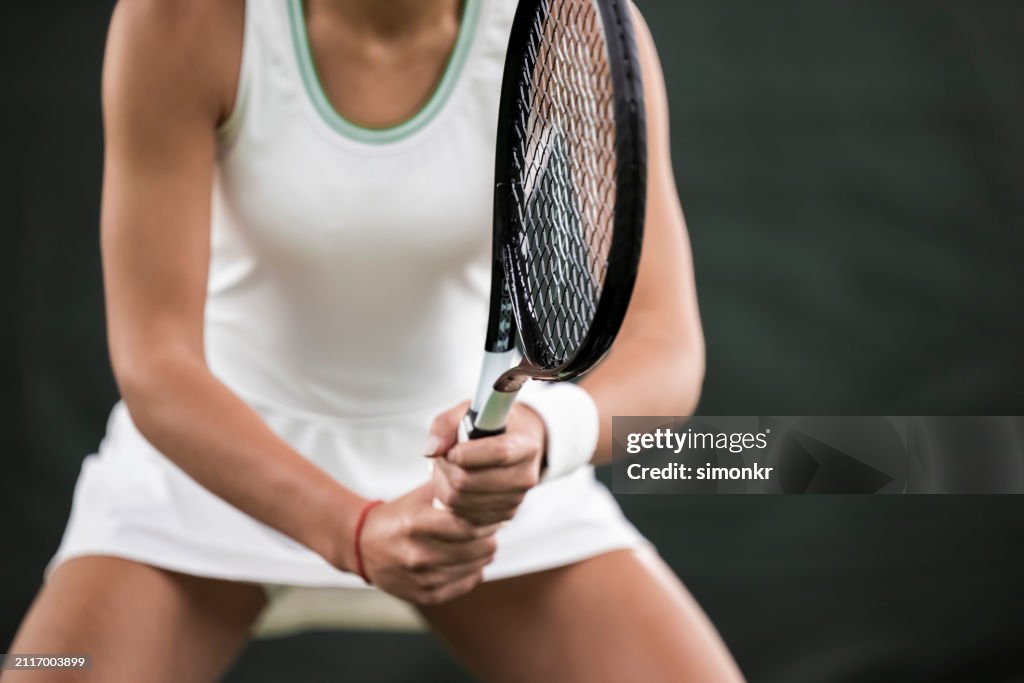 Tennis player playing in tennis court