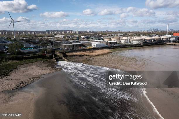 In this aerial view, discharge is seen flowing into the River Thames at Crossness sewage treatment works on March 27, 2024 in London, England. Recent...