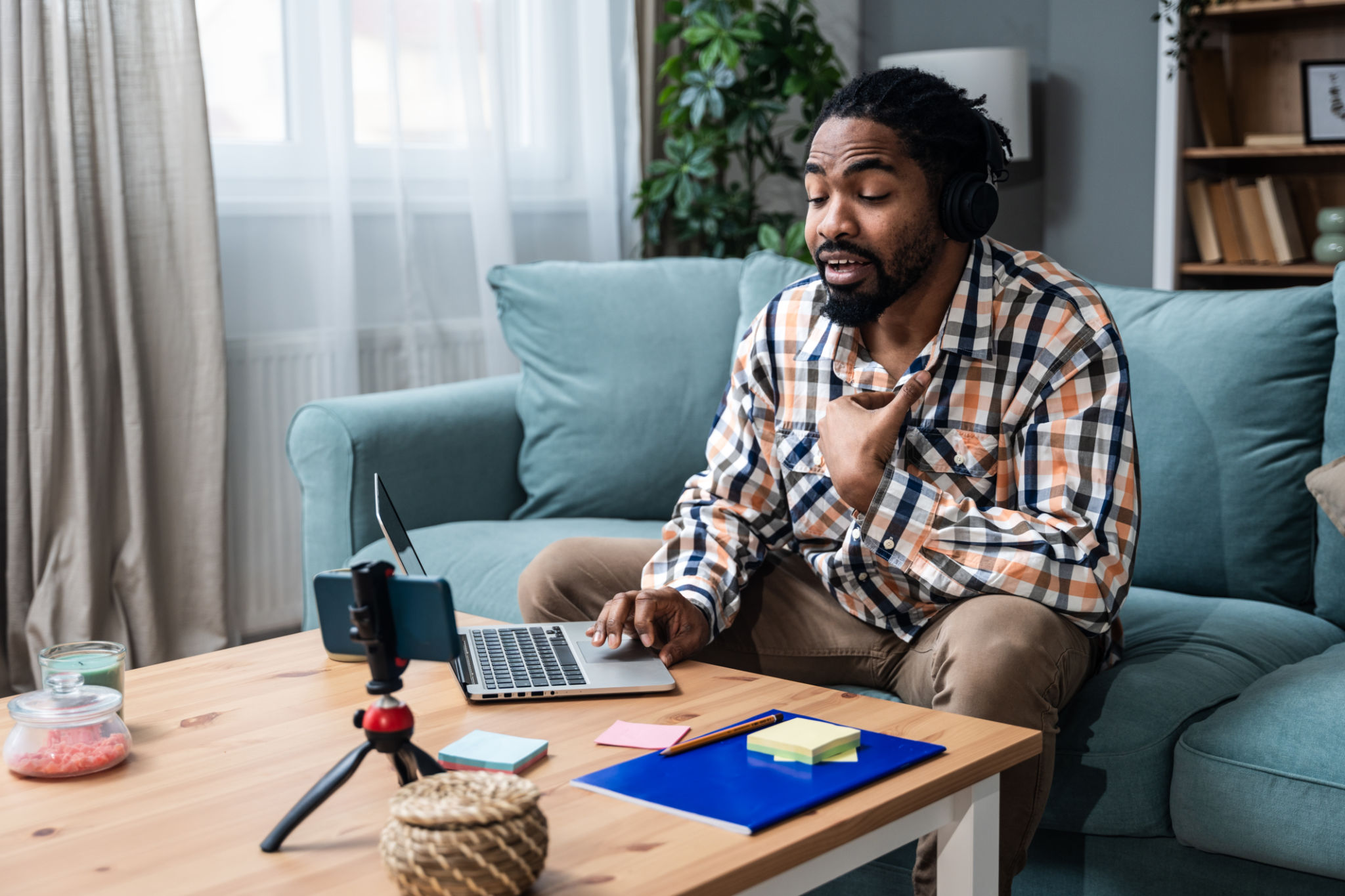 Young African exchange student expatriate freelance business man sitting at home talking on video call on webcam talking about racism and personal negative experience with racism and racial problems. Young African exchange student expatriate freelance business man sitting at home talking on video call on webcam talking about racism and personal negative experience with racism and racial problems.