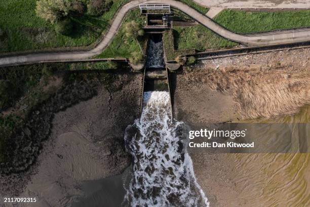Permitted treated final effluent discharge flows into the River Thames at Crossness sewage treatment works on March 27, 2024 in London, England.