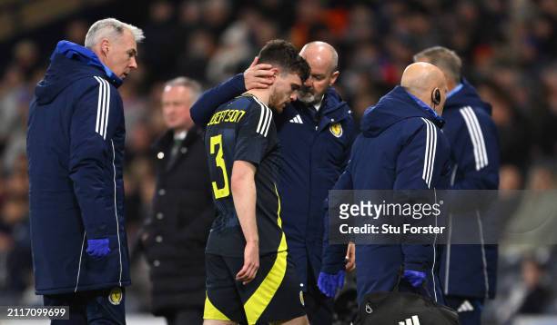Scotland captain Andrew Robertson is consoled by manager Steve Clarke after picking up an injury and subsequently being substituted during the...