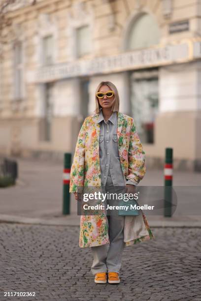 Karin Teigl seen wearing Loewe yellow sunglasses, Agolde light grey denim buttoned jeans shirt, matching Agolde light grey denim straight leg pants,...