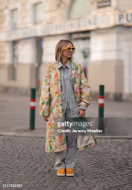 Karin Teigl seen wearing Loewe yellow sunglasses, Agolde light grey denim buttoned jeans shirt, matching Agolde light grey denim straight leg pants,...