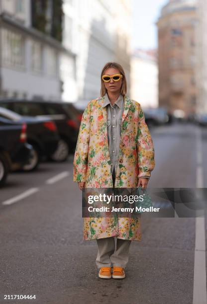 Karin Teigl seen wearing Loewe yellow sunglasses, Agolde light grey denim buttoned jeans shirt, matching Agolde light grey denim straight leg pants,...