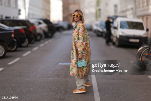 Karin Teigl seen wearing Loewe yellow sunglasses, Agolde light grey denim straight leg pants, Stine Goya yellow with colorful flower embroidered...