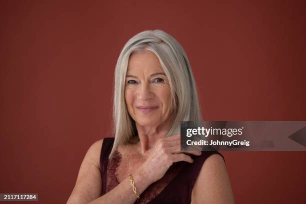 confident woman in early 70s wearing slip, studio shot - petticoat stock pictures, royalty-free photos & images