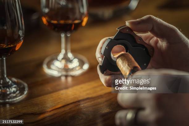 cigars with guillotine cuts off cigars tip in humido - premium lighter stock pictures, royalty-free photos & images
