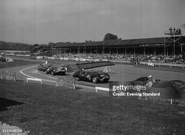 Racing drivers from right, Ron Flockhart in a D-Type Jaguar, Dick Steed in a Cooper T33 Jaguar and Desmond Titterington in a D-Type Jaguar being...