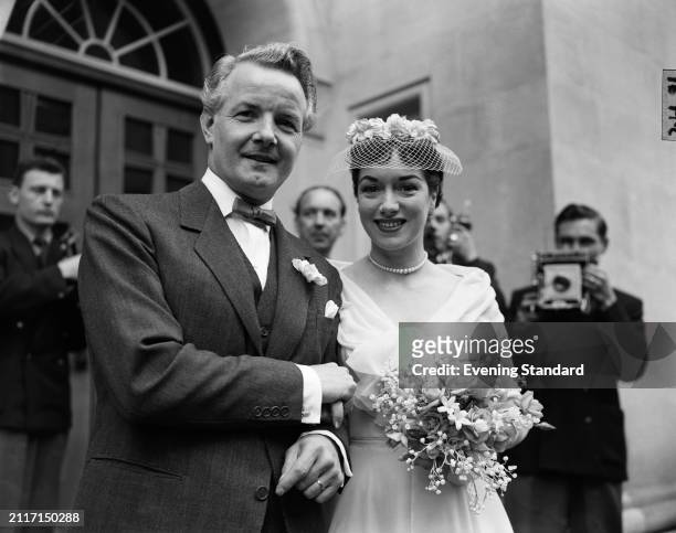 Actress and performer Pat Kirkwood with her husband, actor, theatre director and songwriter Hubert Gregg on their wedding day, St Columba's Church,...