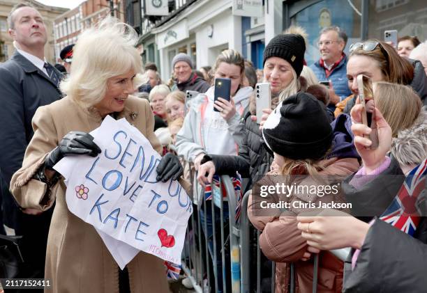 Queen Camilla receives a message of support for Catherine, Princess of Wales from well-wishers during her visit to the Farmers' Market on March 27,...