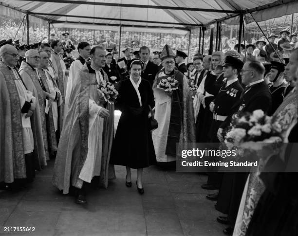 Queen Elizabeth II is led by a priest though an honour guard at the Maundy Thursday Service at Southwark Cathedral, London, April 14th 1955. Prince...