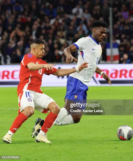 Alexis Sanchez of Chile in action with Aurelien Tchouameni of Team France during the international friendly match between France and Chile at Stade...