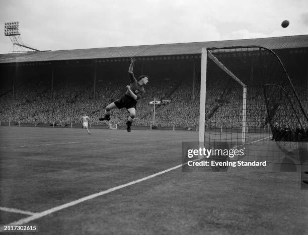 Newcastle Football Club goalkeeper Ronnie Simpson tips the ball over the crossbar to make a save during the FA Cup Final, Wembley Stadium, London,...