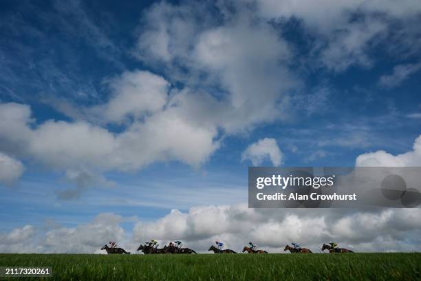 Runners in The Respect In Racing Amateur Jockeys' Handicap Hurdle make their way down the back straight at Wincanton Racecourse on March 27, 2024 in...