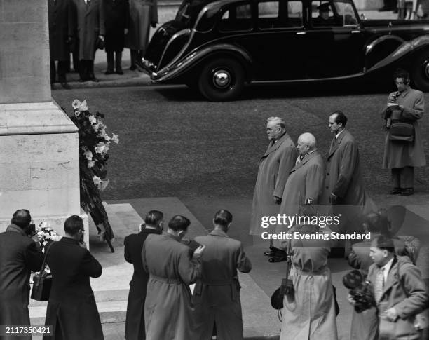 Soviet Premier Nikolai Bulganin first left, and head of state Nikita Khrushchev second left, stand opposite the Cenotaph after laying a wreath,...