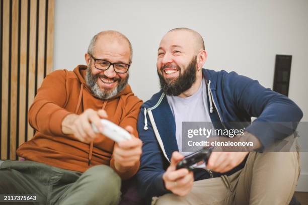 two friends playing video games - man cave stock pictures, royalty-free photos & images