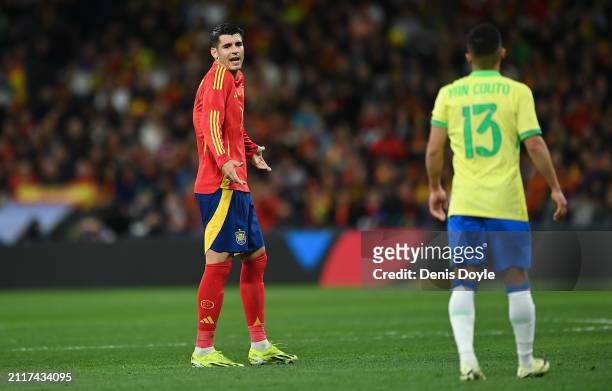 Alvaro Morata of Spain reacts with Yan Couto of Brazil during the friendly match between Spain and Brazil at Estadio Santiago Bernabeu on March 26,...