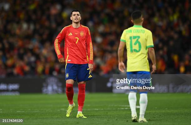 Alvaro Morata of Spain reacts with Yan Couto of Brazil during the friendly match between Spain and Brazil at Estadio Santiago Bernabeu on March 26,...