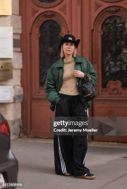Karin Teigl seen wearing Miu Miu black cowboy hat, Zara beige transparent crystal high neck top, Zara dark green puffer bomber jacket, Adidas black...