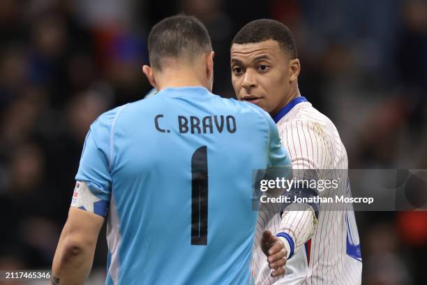 Kylian Mbappe of France reacts with Claudio Bravo of Chile during the international friendly match between France and Chile at Stade Velodrome on...