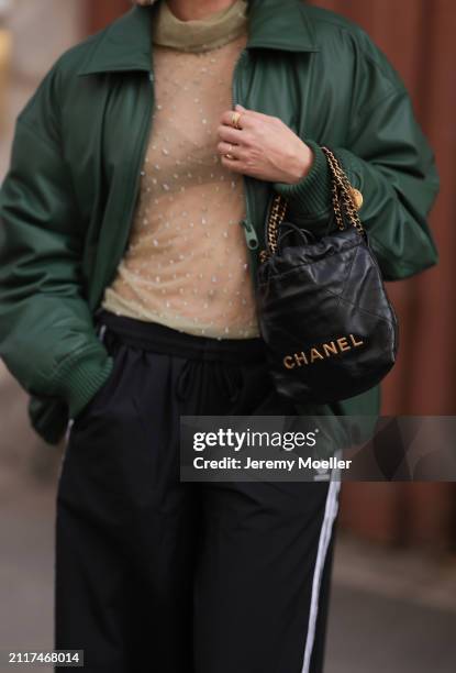 Karin Teigl seen wearing Zara beige transparent crystal high neck top, Zara dark green puffer bomber jacket, Adidas black wide leg track pants,...