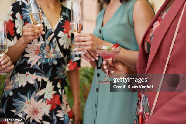 midsection of female guests with alcoholic drinks - design by hand series celebration stock pictures, royalty-free photos & images