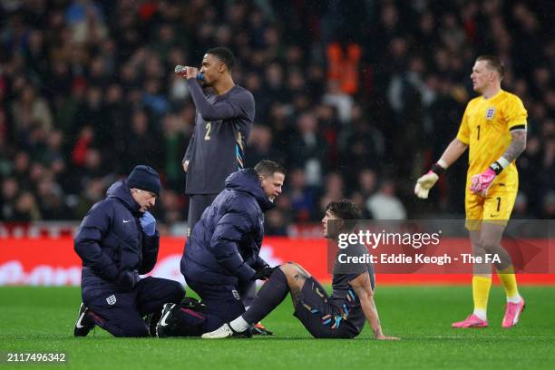 John Stones of England receives medical treatment after picking up an injury before being substituted during the international friendly match between...