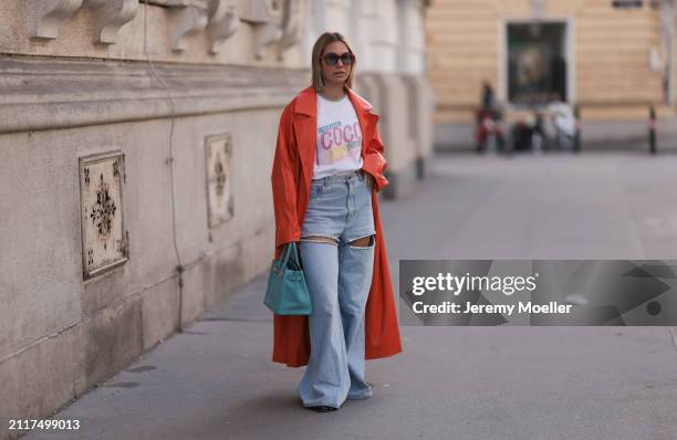 Karin Teigl seen wearing Jacques Marie Mage brown sunglasses with blue lenses, Chanel Coco white with colorful logo print cotton t-shirt, Aera light...