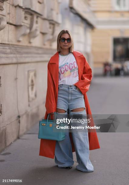 Karin Teigl seen wearing Jacques Marie Mage brown sunglasses with blue lenses, Chanel Coco white with colorful logo print cotton t-shirt, Aera light...