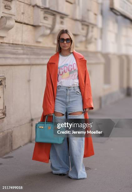 Karin Teigl seen wearing Jacques Marie Mage brown sunglasses with blue lenses, Chanel Coco white with colorful logo print cotton t-shirt, Aera light...