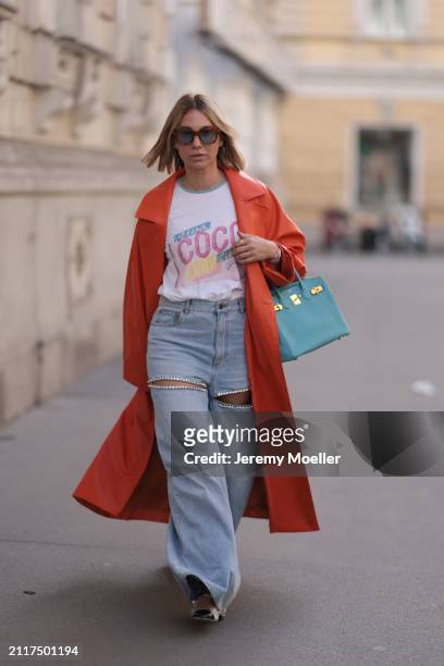 Karin Teigl seen wearing Jacques Marie Mage brown sunglasses with blue lenses, Chanel Coco white with colorful logo print cotton t-shirt, Aera light...