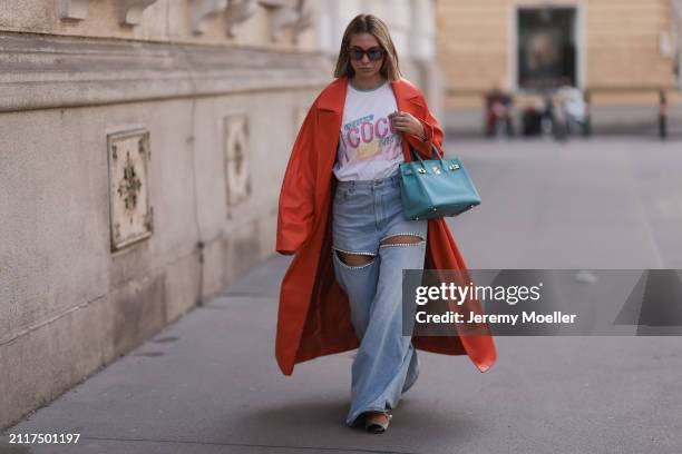 Karin Teigl seen wearing Jacques Marie Mage brown sunglasses with blue lenses, Chanel Coco white with colorful logo print cotton t-shirt, Aera light...