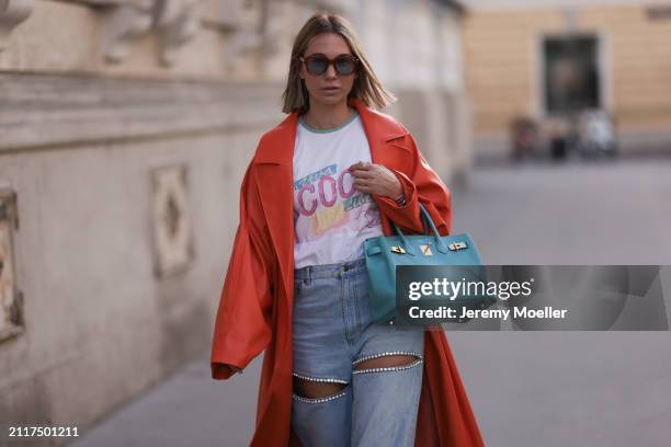 Karin Teigl seen wearing Jacques Marie Mage brown sunglasses with blue lenses, Chanel Coco white with colorful logo print cotton t-shirt, Aera light...