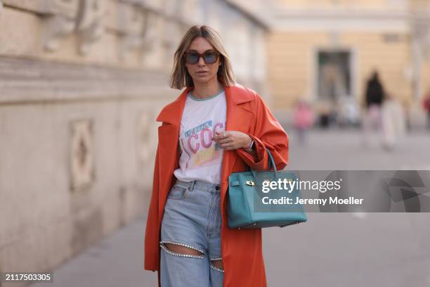 Karin Teigl seen wearing Jacques Marie Mage brown sunglasses with blue lenses, Chanel Coco white with colorful logo print cotton t-shirt, Aera light...