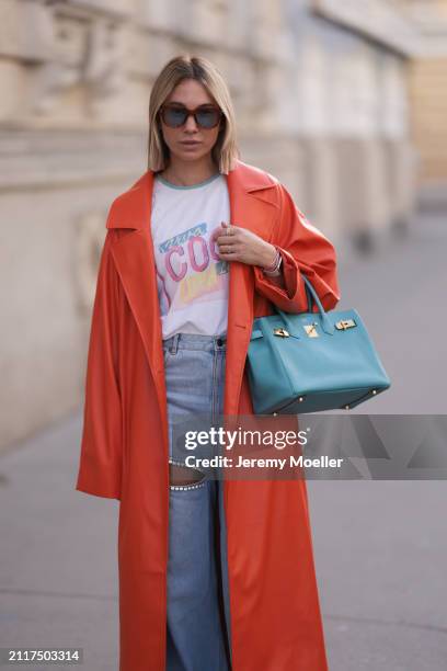 Karin Teigl seen wearing Jacques Marie Mage brown sunglasses with blue lenses, Chanel Coco white with colorful logo print cotton t-shirt, Aera light...