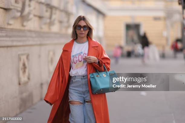 Karin Teigl seen wearing Jacques Marie Mage brown sunglasses with blue lenses, Chanel Coco white with colorful logo print cotton t-shirt, Aera light...