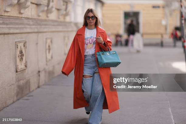 Karin Teigl seen wearing Jacques Marie Mage brown sunglasses with blue lenses, Chanel Coco white with colorful logo print cotton t-shirt, Aera light...