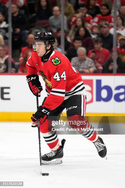 Wyatt Kaiser of the Chicago Blackhawks skates with the puck during the first period against the Calgary Flames at the United Center on March 26, 2024...
