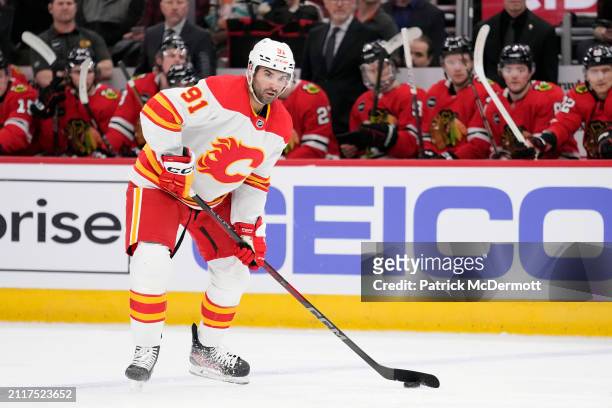 Nazem Kadri of the Calgary Flames skates with the puck during the first period against the Chicago Blackhawks at the United Center on March 26, 2024...