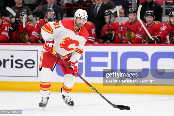 Nazem Kadri of the Calgary Flames skates with the puck during the first period against the Chicago Blackhawks at the United Center on March 26, 2024...