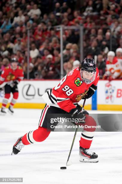 Connor Bedard of the Chicago Blackhawks skates with the puck during the second period against the Calgary Flames at the United Center on March 26,...