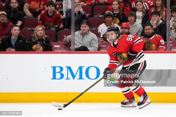 Connor Bedard of the Chicago Blackhawks skates with the puck during the second period against the Calgary Flames at the United Center on March 26,...