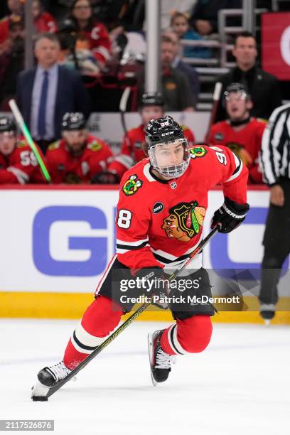 Connor Bedard of the Chicago Blackhawks skates with the puck during the second period against the Calgary Flames at the United Center on March 26,...