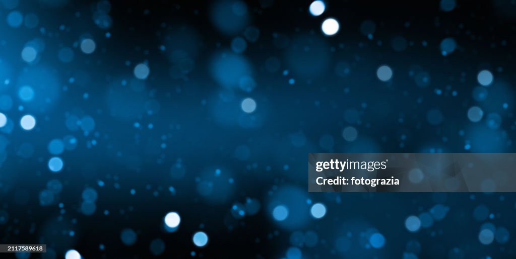 Blue Defocused Lights over Dark Background