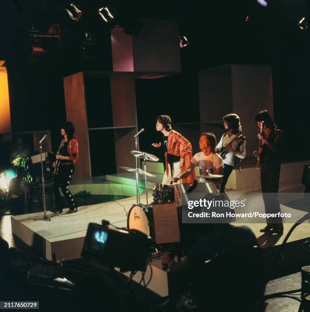 English rock group The Rolling Stones perform the song 'Honky Tonk Woman' on the set of a pop music television show in London in July 1969. Members...