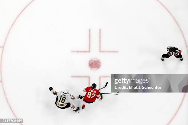 Kevin Stenlund of the Florida Panthers skates with the puck against Pavel Zacha of the Boston Bruins at the Amerant Bank Arena on March 26, 2024 in...