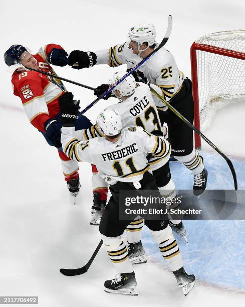 Matthew Tkachuk of the Florida Panthers tangles with Brandon Carlo, Charlie Coyle and Trent Frederic of the Boston Bruins at the Amerant Bank Arena...