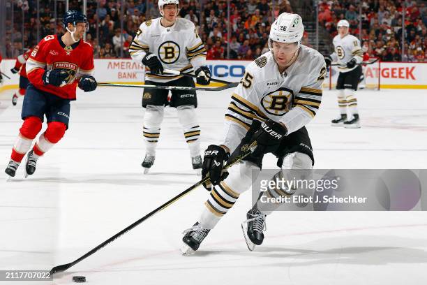 Brandon Carlo of the Boston Bruins skates with the puck against the Florida Panthers at the Amerant Bank Arena on March 26, 2024 in Sunrise, Florida.