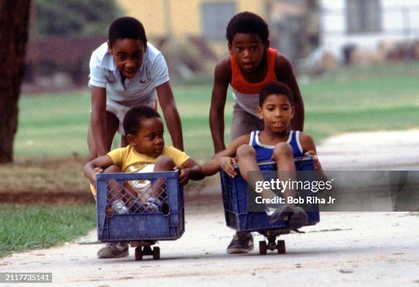 Tracey Hill and his brother Brian Hill challenge a race with friends Pookie Eddie and Jeraton Petrie in a modified milk crate-skateboard setup,...