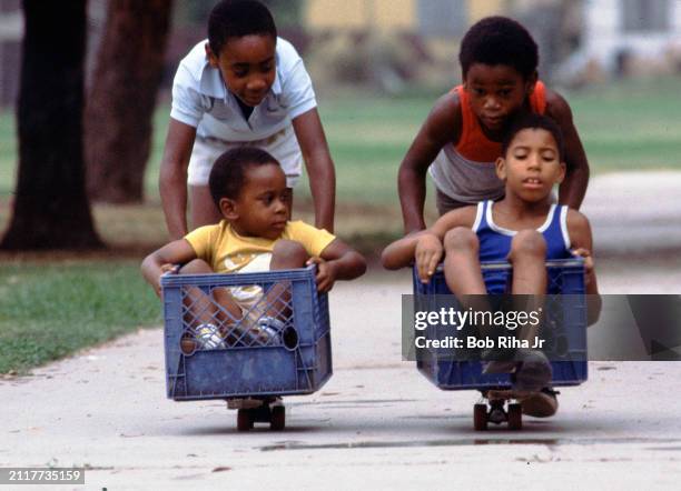 Tracey Hill and his brother Brian Hill challenge a race with friends Pookie Eddie and Jeraton Petrie in a modified milk crate-skateboard setup,...